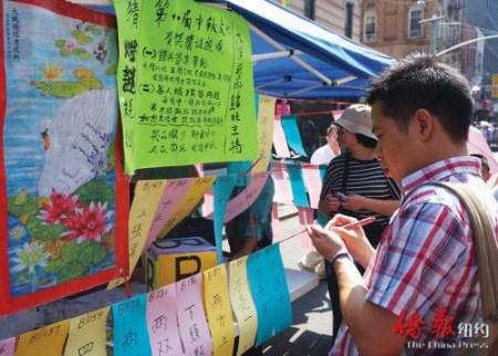 民眾現(xiàn)場參加中秋猜燈謎游戲。(美國《僑報》/陳辰 攝) 