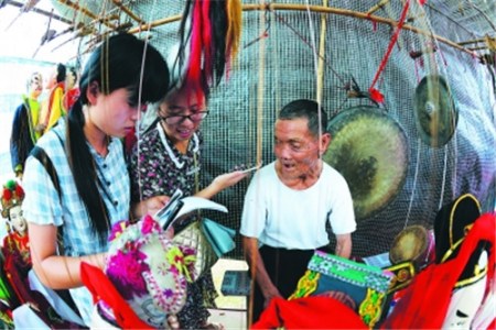  一位70多歲的客家提線木偶老藝人，正在接受龍巖當(dāng)?shù)卮髮W(xué)生的訪問。