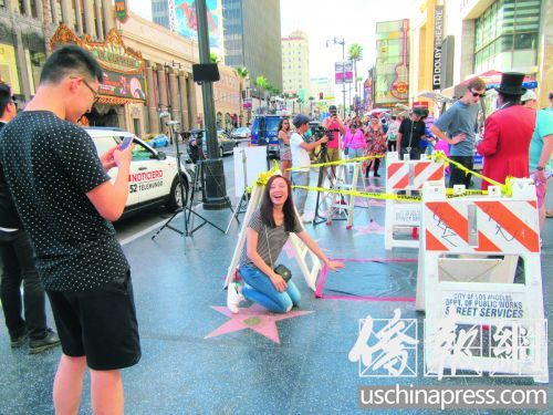 一對情侶在留影拍照時并不知道這是特朗普之星被破壞現(xiàn)場。(美國《僑報》/翁羽 攝)