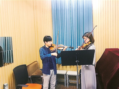 江博在寫簡歷時注意將學(xué)習(xí)經(jīng)歷、演出經(jīng)歷、獲獎等分開來寫，突出重要和有影響力的部分。但是，演奏水平卻無法靠簡歷寫得漂亮去證明。通過面試，江博成為了一名大學(xué)音樂教師。圖為江博在教學(xué)生拉小提琴。