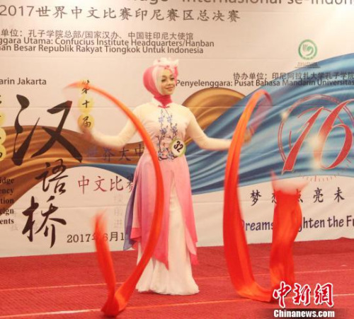 圖為大學(xué)生組選手表演彩綢舞?！×钟纻?攝