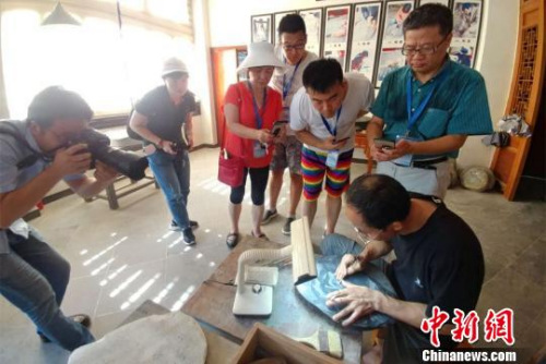 圖為采訪團在熹園觀看歙硯制作流程。　華山　攝