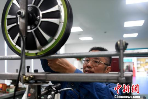 許啟金在工作室中研制工具?！№n蘇原 攝