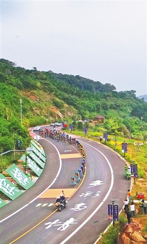 環(huán)島賽選手經(jīng)過萬寧濱海旅游公路。
