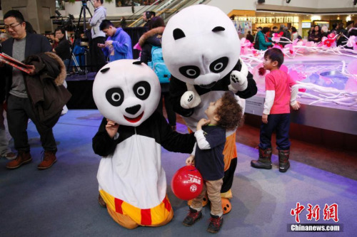 當?shù)貢r間2月11日，加拿大第二大城市蒙特利爾舉行歡樂春節(jié)廟會。圖為現(xiàn)場工作人員扮演的“大熊貓”吸引當?shù)亍把笸尥蕖钡哪抗?。這是蒙城連續(xù)第二年在農(nóng)歷新年前夕由華人社區(qū)聯(lián)合舉辦歡樂春節(jié)廟會。參與籌辦廟會的僑團由第一屆的70多個增至本屆的近百個。<a target='_blank' >中新社</a>記者 余瑞冬 攝