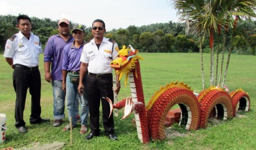 沙比安（右起）、阿都拉、阿茲曼和山蘇利與他們精心制作的龍模型。（馬來西亞《星洲日報》）