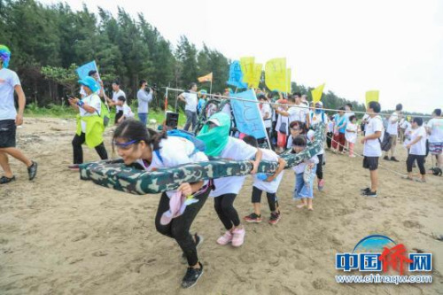 市民和游客體驗潭門趕海運動會合力過桿活動?！±钚娜?攝