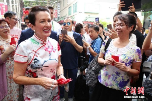 2月5日，中國農(nóng)歷新年大年初一，悉尼市長克羅芙·摩爾（左）到唐人街拜年，與商戶和游人共慶中國新年。圖為摩爾向游人派發(fā)利是紅包。<a target='_blank' >中新社</a>記者 陶社蘭 攝