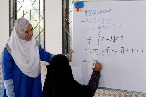 盧萊茵在課堂上教導學生用華文字寫出日期。(馬來西亞《星洲日報》/陳敬暉 攝)