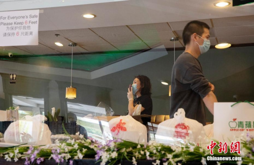 遼寧人汪女士與合伙人5年前在這里開了“青蘋果”餐館。她坦言，現(xiàn)在餐館的狀態(tài)就是“生存，能挺下來就行”。圖為汪女士用微信與客戶交流。<a target='_blank' >中新社</a>記者 劉關(guān)關(guān) 攝