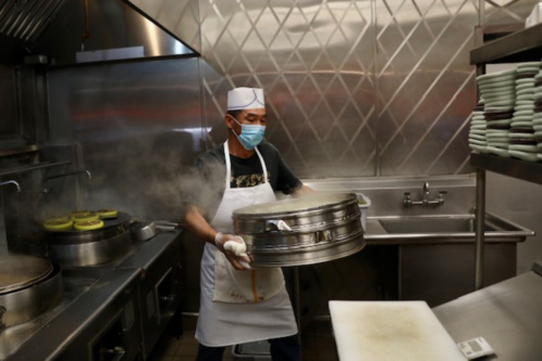 　餐廳后廚溫師傅說(shuō)，開(kāi)設(shè)戶外餐飲區(qū)生意好了，能感覺(jué)得到。(美國(guó)《僑報(bào)》記者 邱晨攝) 