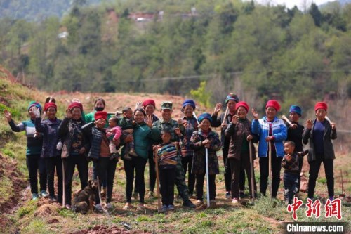 布哈與村名們一同種植果樹時(shí)合影。圖片由武警部隊(duì)提供