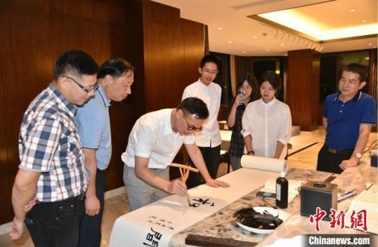 臺(tái)青、臺(tái)灣中華青年發(fā)展聯(lián)合會(huì)副理事長(zhǎng)游智彬書寫“和合” 范宇斌 攝