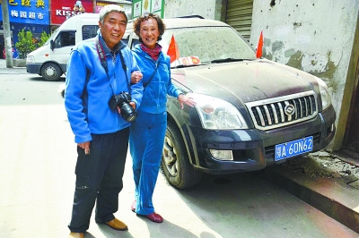 中國僑網(wǎng)圖為陳愛武和老伴在愛車前。(楊濤 攝)