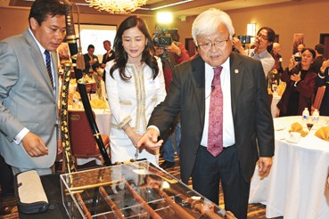 中國僑網(wǎng)本田(右)參觀劉磊(左)收藏的軍刀。(美國《世界日報》/王湛 攝)