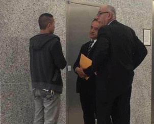 李林丈夫鄭祖勝(左)在庭外與翻譯和辯護律師溝通。(美國《僑報》/高詩云