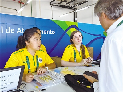 侯嘉怡(左一)在媒體注冊(cè)中心為記者提供語(yǔ)言翻譯服務(wù)