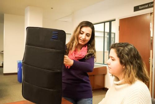 中國僑網(wǎng)學(xué)校教師正在嘗試展開便攜防彈盾。(美國《僑報》)