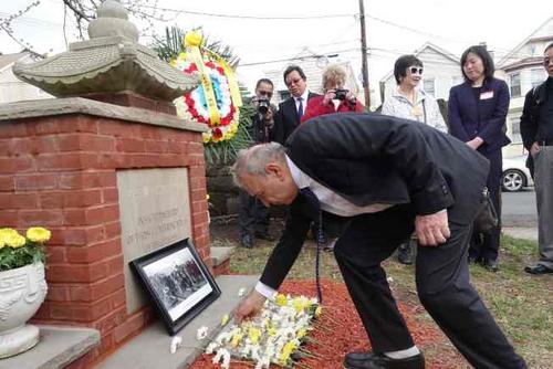 中國僑網(wǎng)貝勒維爾歷史學會主席佩羅內(nèi)為華工獻花。(美國《世界日報》/謝哲澍 攝)