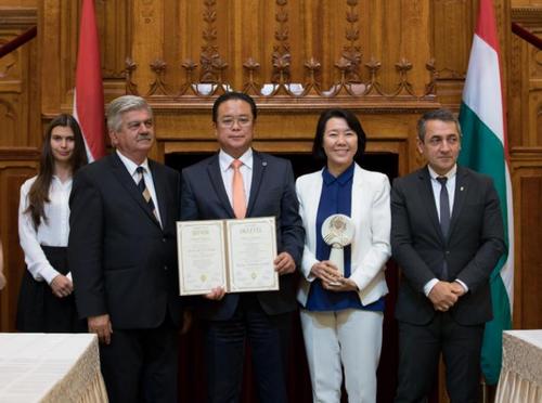 中國(guó)僑網(wǎng)匈牙利總理府國(guó)務(wù)秘書阿爾巴德(右一)、農(nóng)業(yè)部副部長(zhǎng)Sándor Farkas(左一)為匈牙利東方國(guó)藥集團(tuán)創(chuàng)始人陳震博士(左二)及王帆博士(右二)頒發(fā)獎(jiǎng)杯及榮譽(yù)證書。