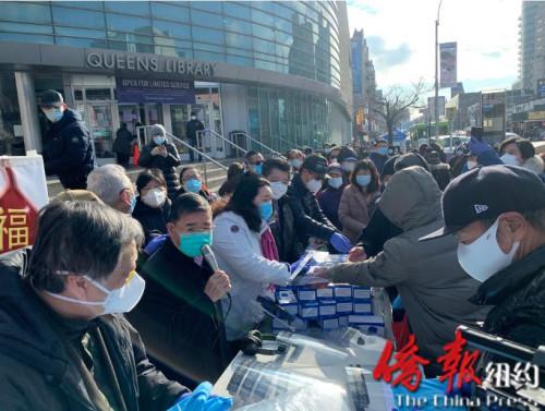 中國僑網(wǎng)華商會(huì)向法拉盛民眾派發(fā)口罩等防疫物資。(美國《僑報(bào)》/張晶 攝)
