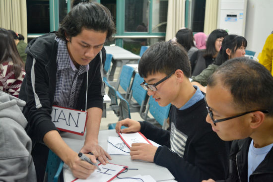 印尼語教師在為學(xué)員們?nèi)∮∧崦?/