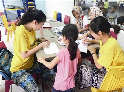 顧碩宇、孫圓媛和難民學生在一起。