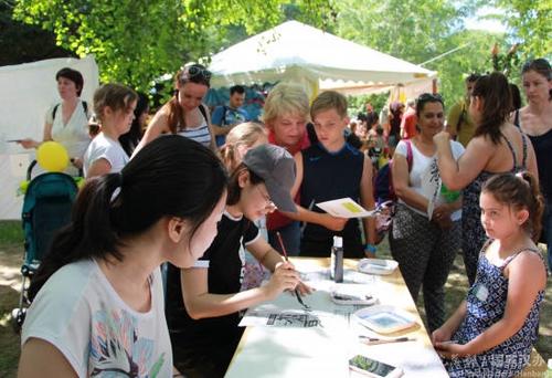 中國僑網(wǎng)志愿者為當?shù)貎和瘯鴮懼形拿帧? /></div><!--圖片--><!--圖片說明-->
<div id=