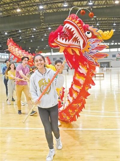中國(guó)僑網(wǎng)選手嘗試舞龍
