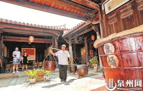 中國僑網(wǎng)“紅色糧倉”講解員曾火炎向參觀者展示農(nóng)具