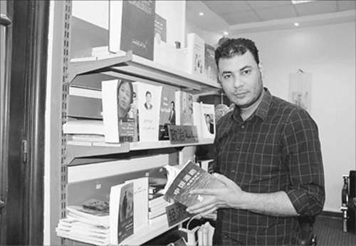 在位于開羅的公司陳列室,白鑫向記者展示《中國道路》一書。(劉水明