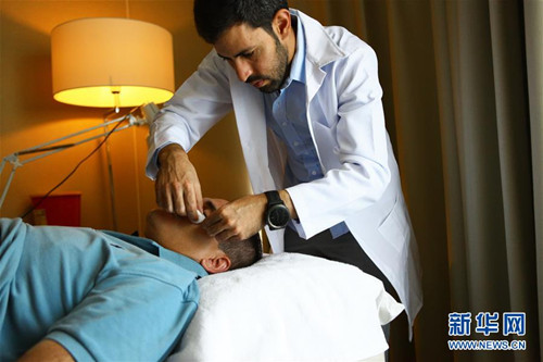 這是2016年9月16日在拉姆安拉拍攝的烏薩馬·哈比巴拉為病人診病的資料照片。