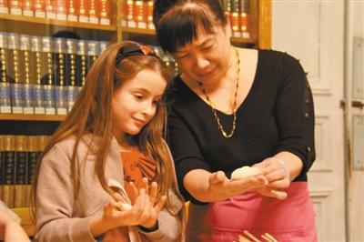 中國僑網(wǎng)一名法國小女孩在巴黎中國文化中心學(xué)習(xí)包餃子。 本報記者 龔鳴 攝